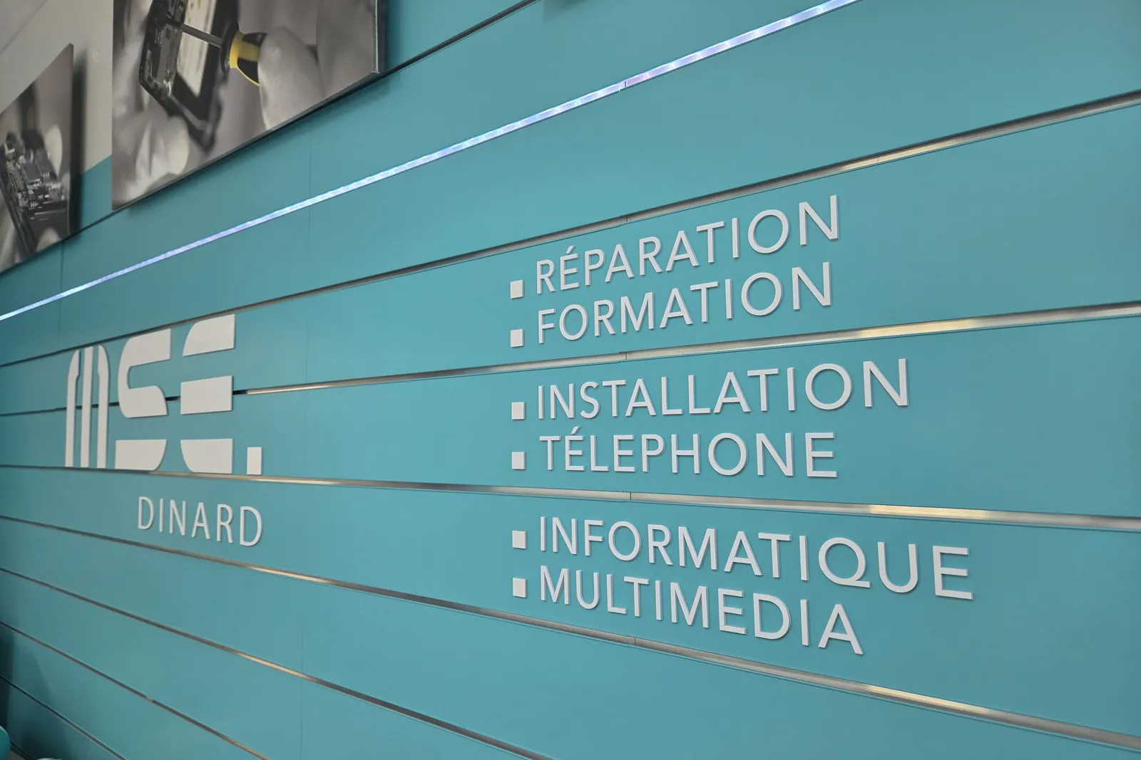 Mur de la boutique de Dinard : réparation, formation, installation, téléphone, informatique, multimédia